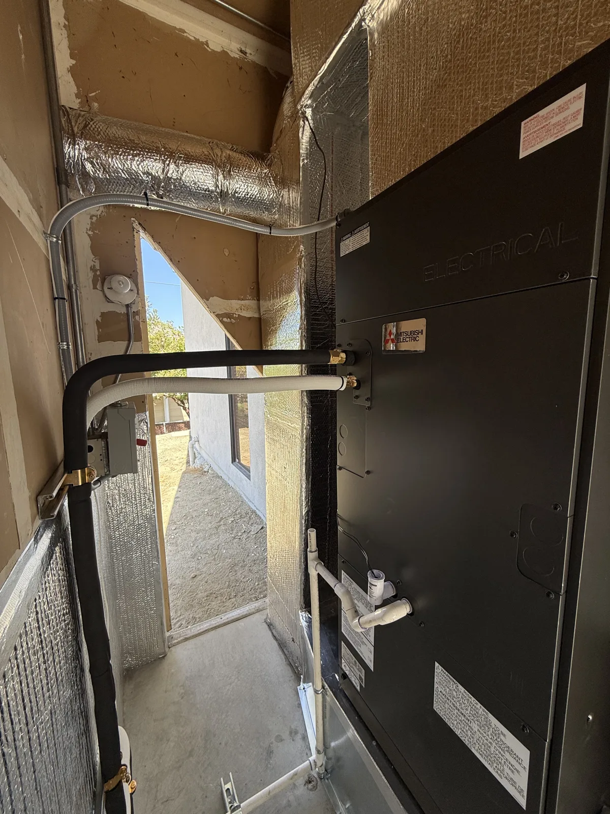 Custom attic air handler installation with sealed refrigerant lines and condensate drain